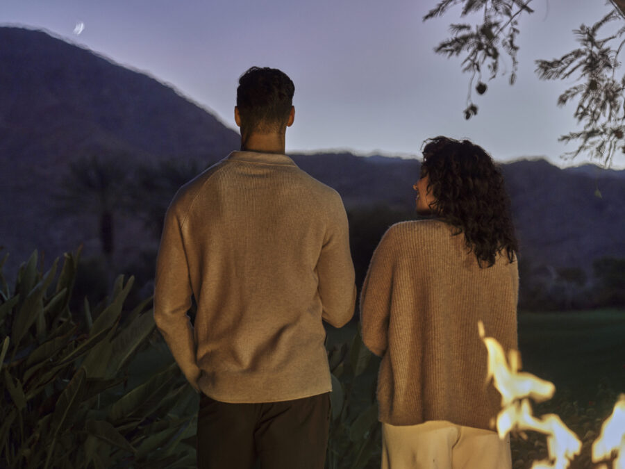Couple standing next to a bon fire